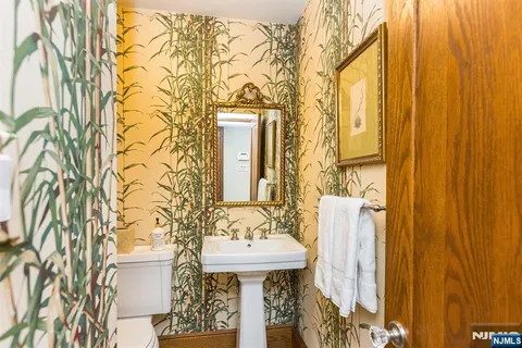 a bathroom with a sink and mirror with shower