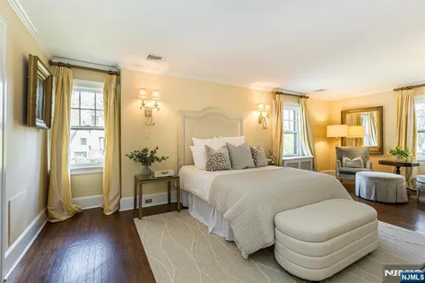 a spacious bedroom with a bed and a couch
