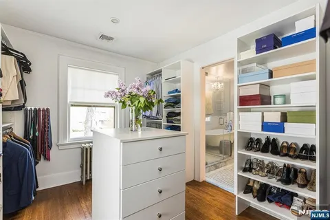 a view of walk in closet with clothes and shoes