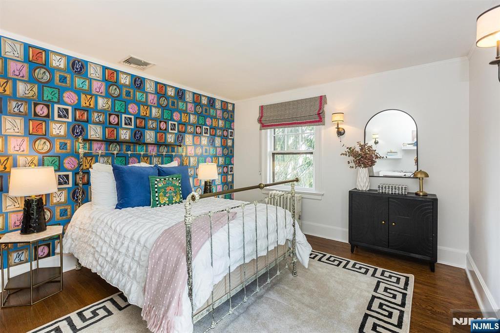 13 Ferncliff Terrace Glen Ridge, NJ 07028 - Photo 28 of 49 a bedroom with a bed and a dresser next to a window