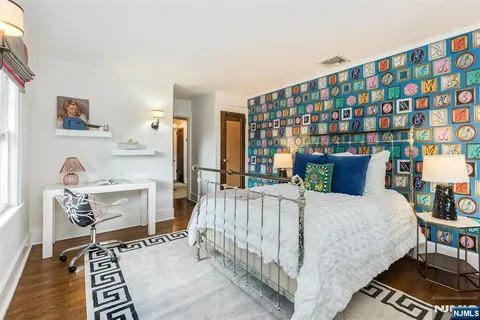 a bed room with a bed and a chair