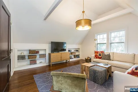 a bedroom with a bed and a television