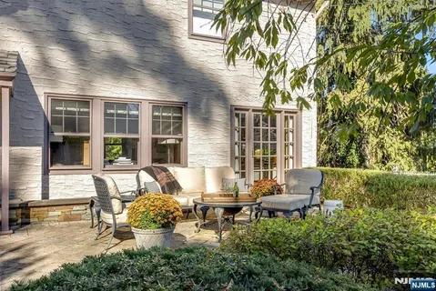 a view of a patio with table and chairs and potted plants