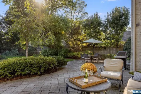a backyard of a house with table and chairs