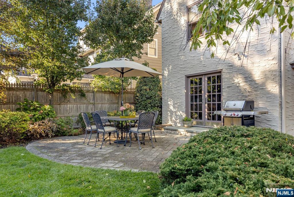 13 Ferncliff Terrace Glen Ridge, NJ 07028 - Photo 44 of 49 a view of a patio with table and chairs under an umbrella