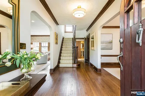 a hallway with wooden floor and furniture