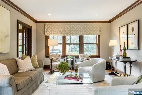 a living room with furniture and large windows
