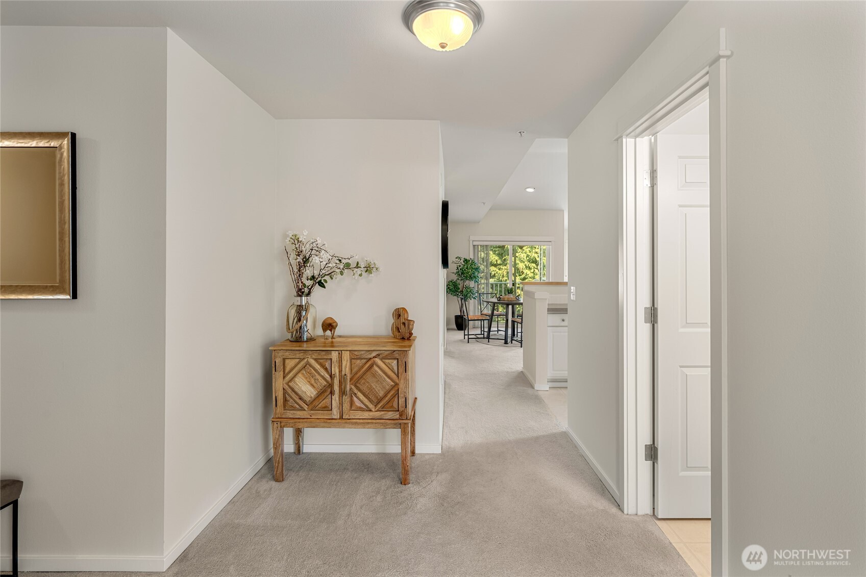 2009 196th Street Southeast, Unit E304 Bothell, WA 98012 - Photo 16 of 36 a view of a hallway and a livingroom with furniture