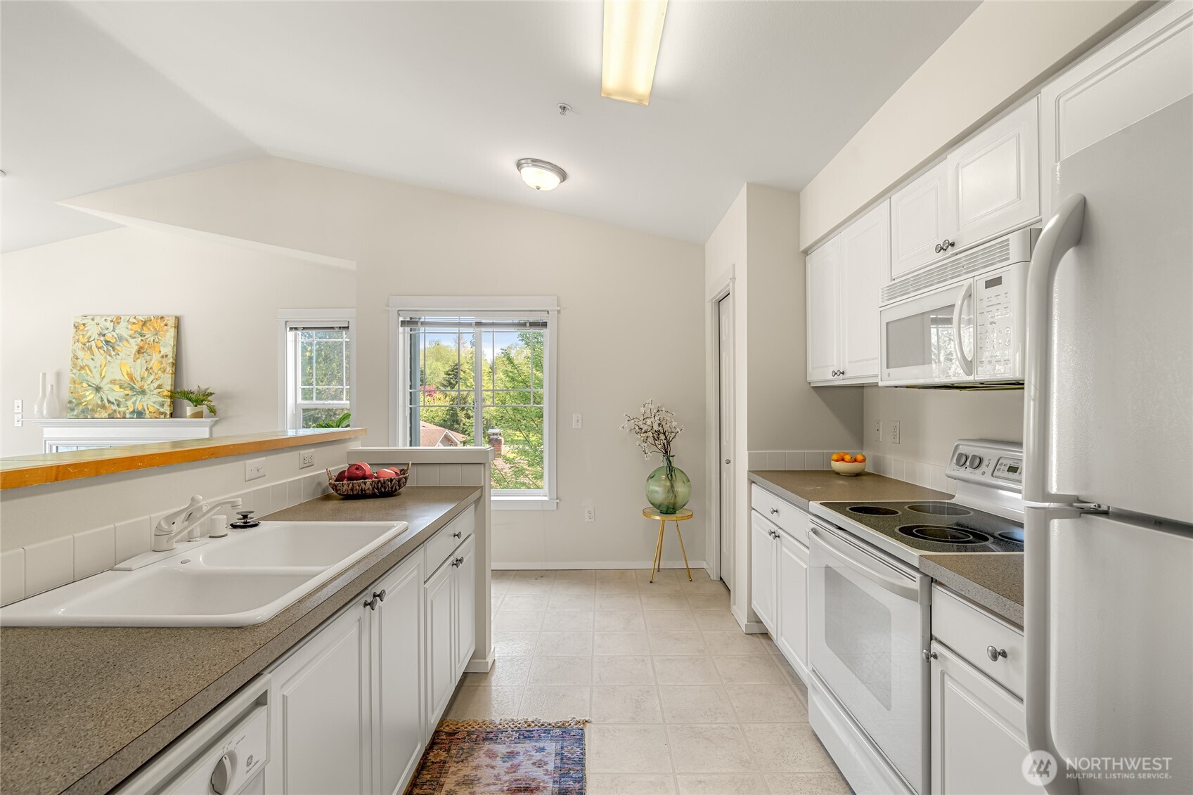 2009 196th Street Southeast, Unit E304 Bothell, WA 98012 - Photo 22 of 36 a kitchen with stainless steel appliances a sink stove and cabinets