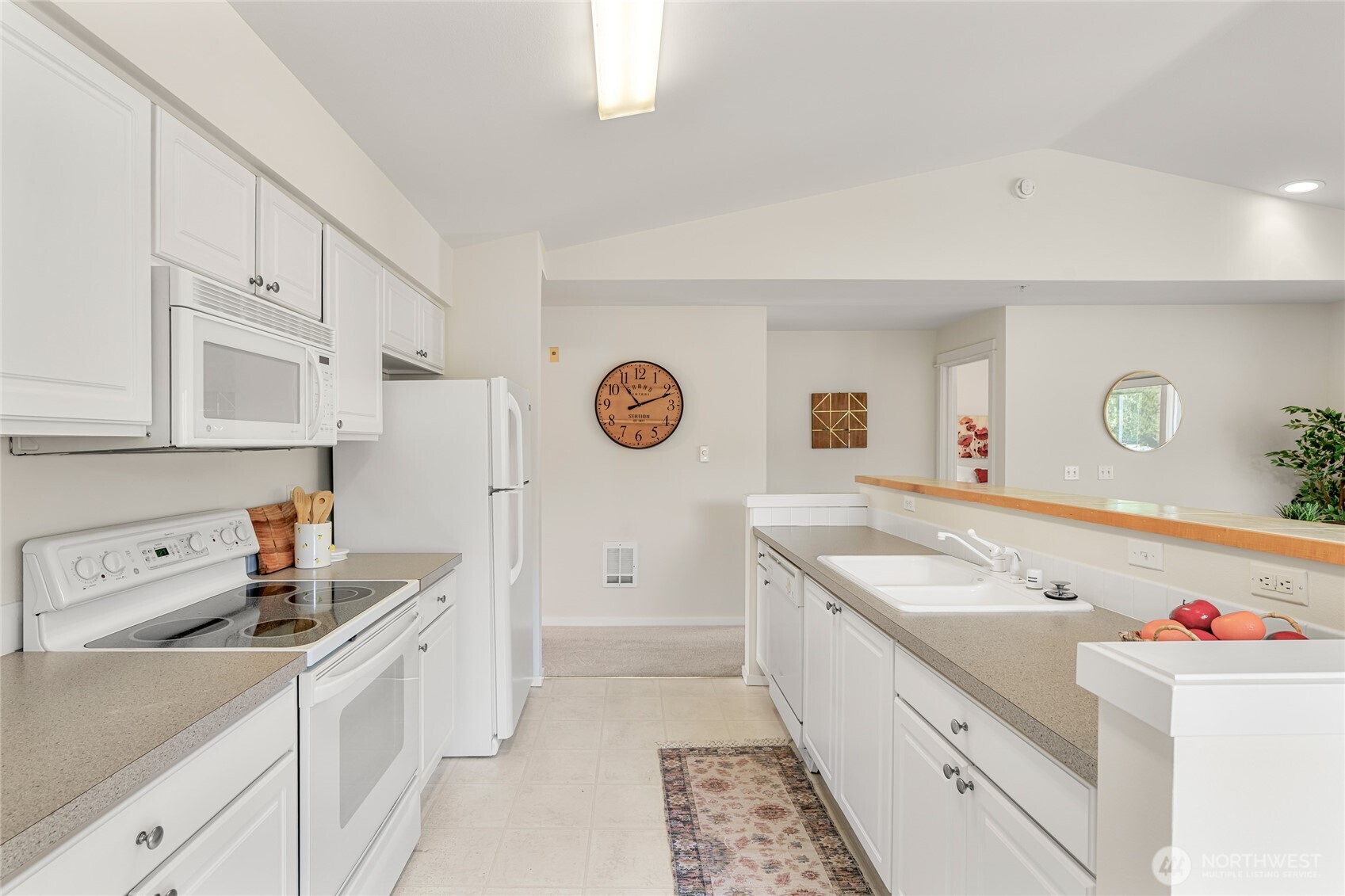 2009 196th Street Southeast, Unit E304 Bothell, WA 98012 - Photo 23 of 36 a kitchen with a sink a stove and cabinets