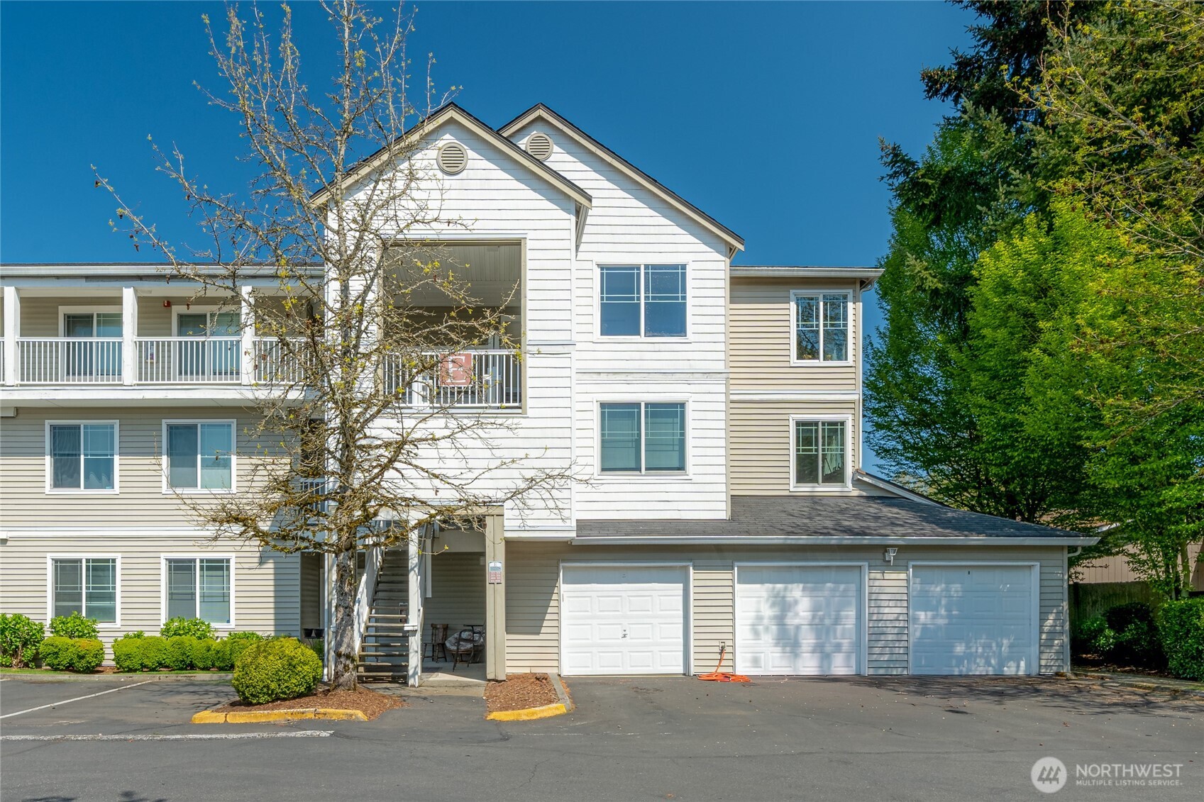 2009 196th Street Southeast, Unit E304 Bothell, WA 98012 - Photo 27 of 36 a front view of a house with a yard and garage