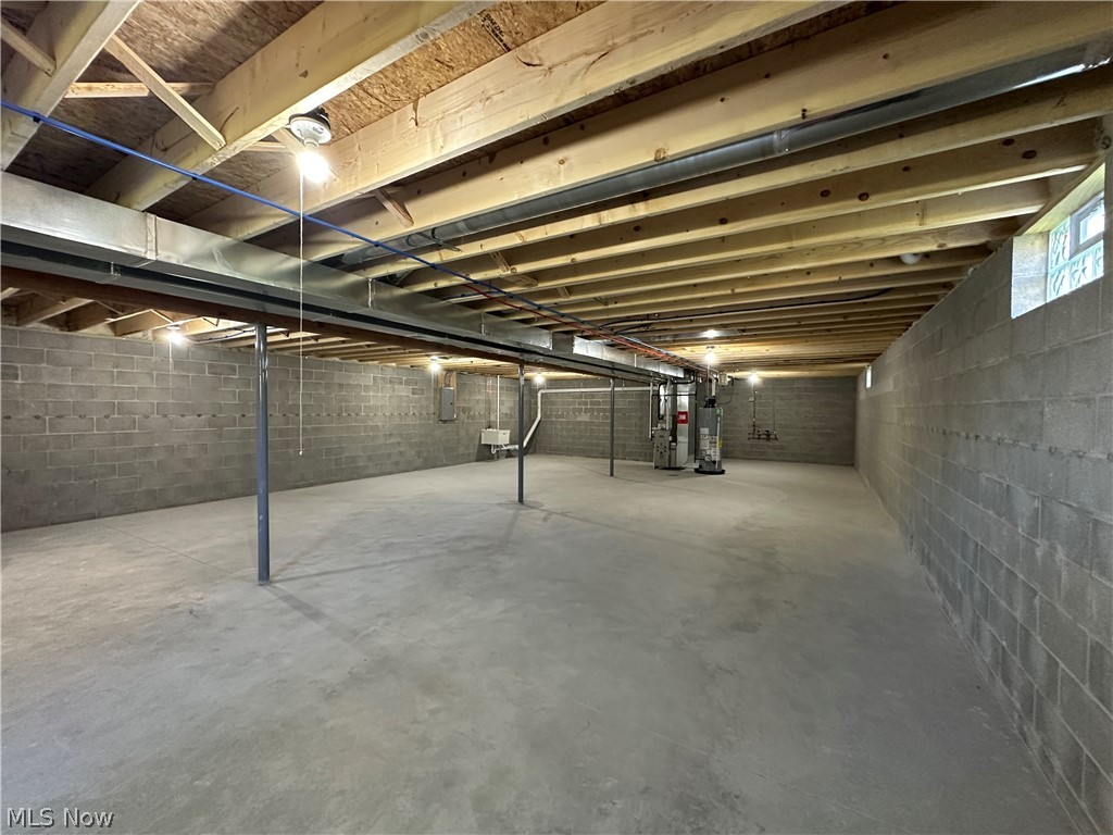 363 Sexton Street Struthers, OH 44471 - Photo 19 of 20 Unfinished basement featuring concrete block walls, exposed wood ceiling joists, and concrete flooring