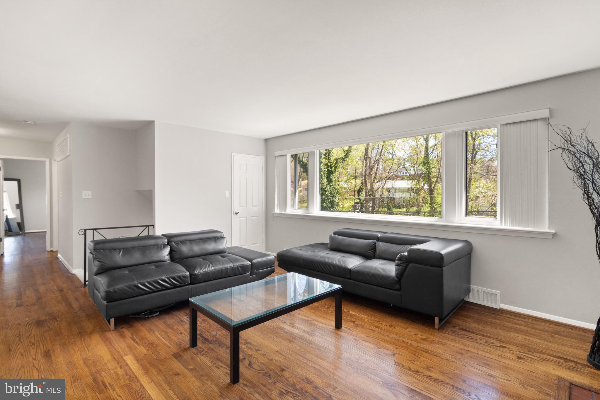 7516 Essex Avenue Springfield, VA 22150 - Photo 15 of 36 a living room with furniture and a flat screen tv with wooden floor