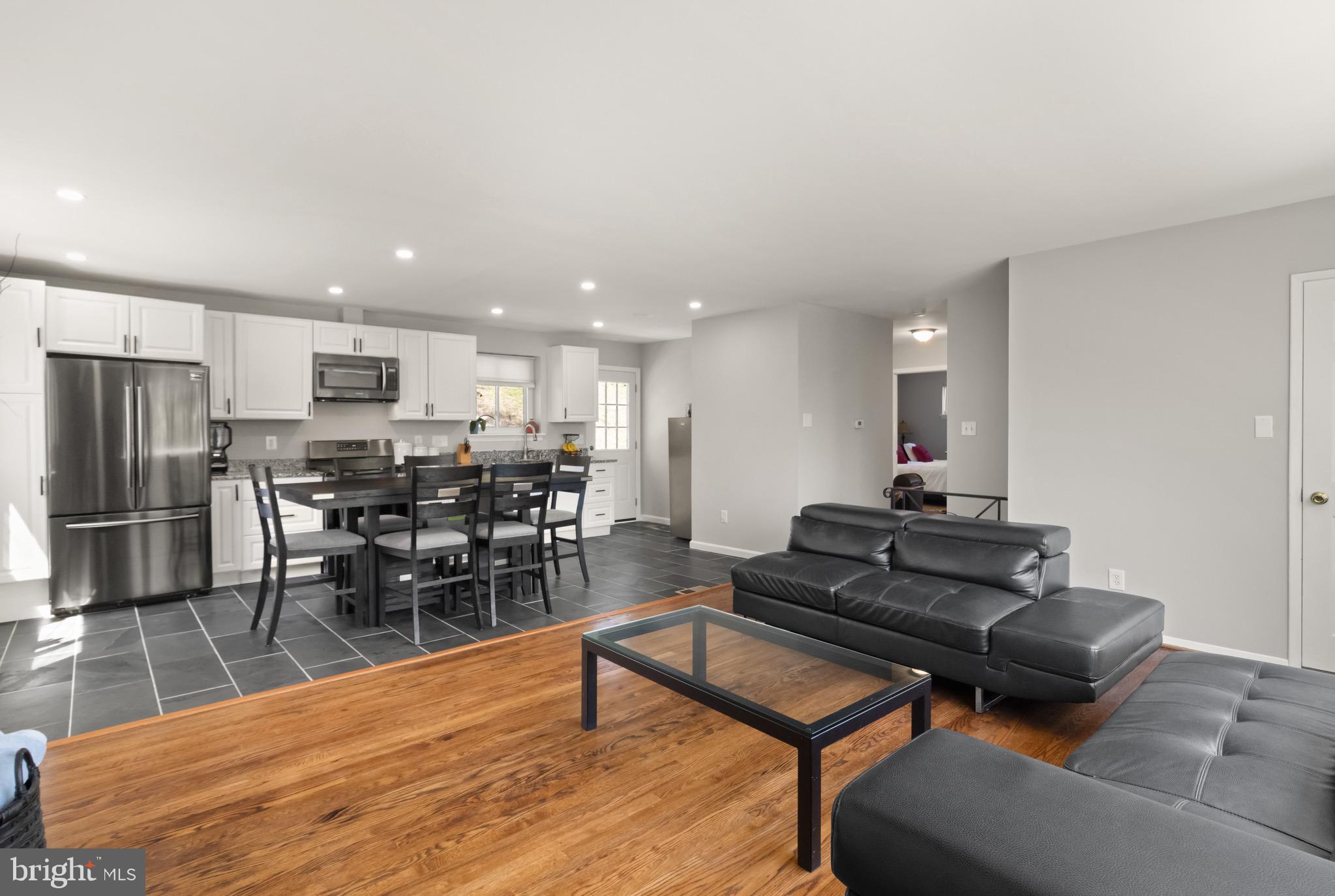 7516 Essex Avenue Springfield, VA 22150 - Photo 16 of 36 a living room with furniture kitchen view and a dining table