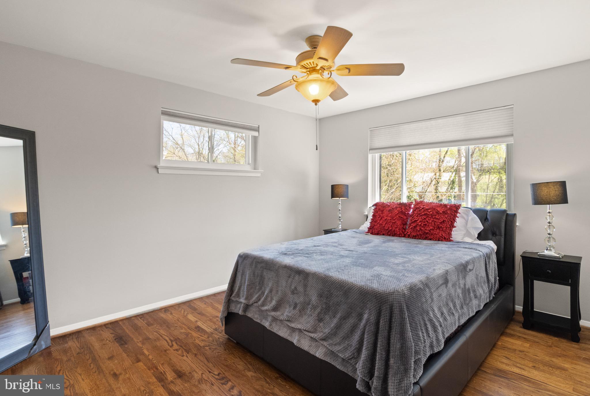 7516 Essex Avenue Springfield, VA 22150 - Photo 18 of 36 a bedroom with a bed and a chandelier