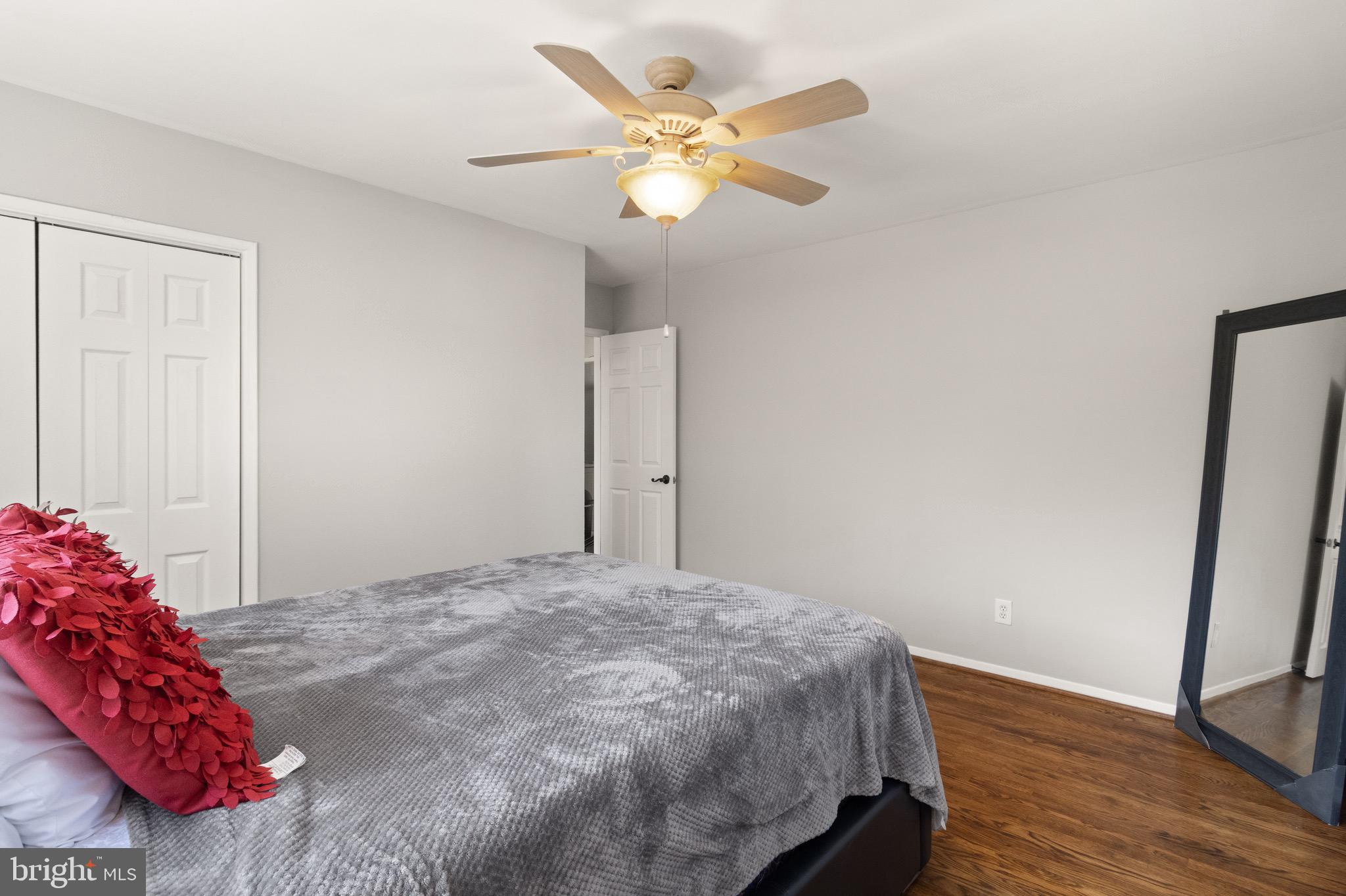 7516 Essex Avenue Springfield, VA 22150 - Photo 20 of 36 a bedroom with a bed and a chandelier