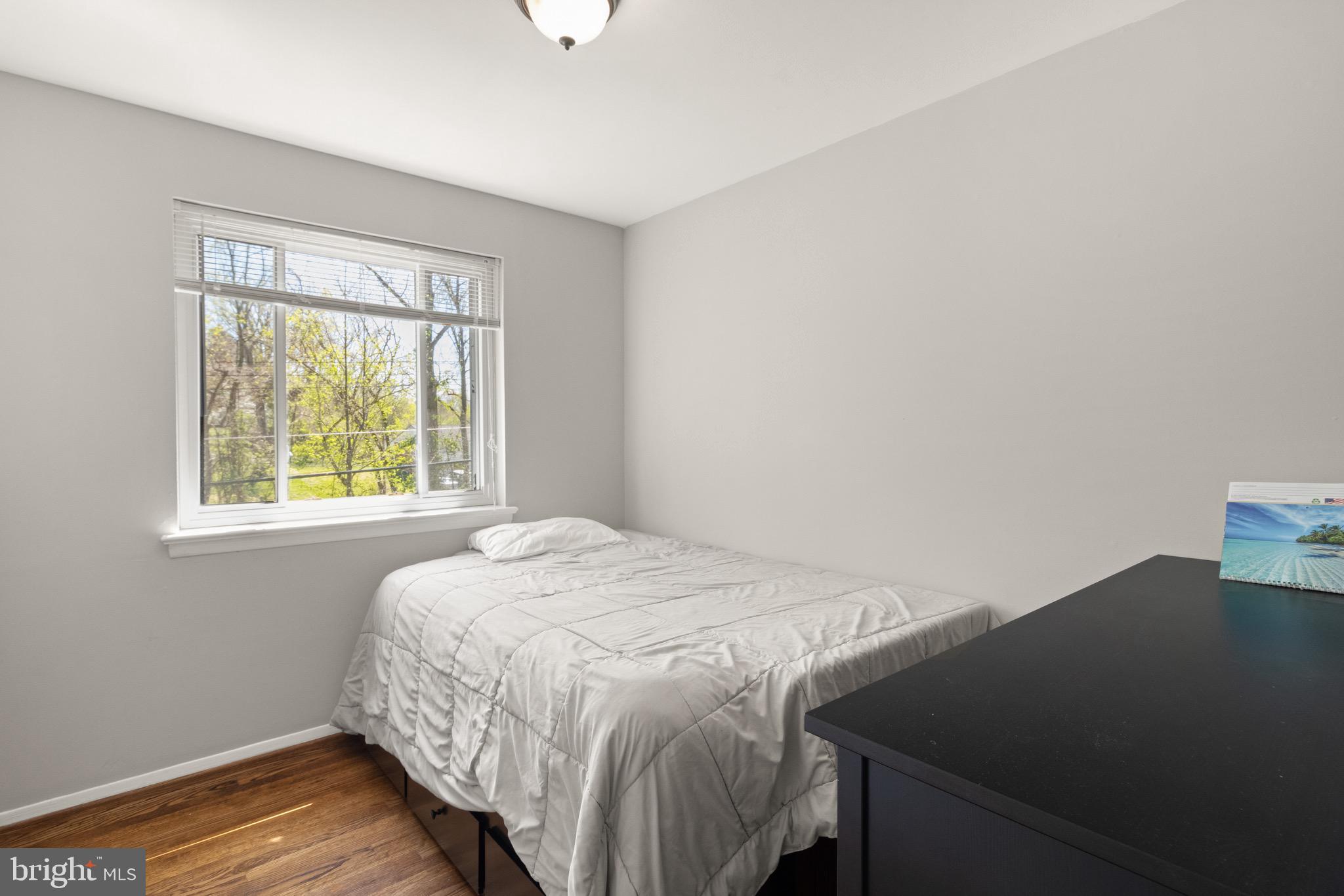 7516 Essex Avenue Springfield, VA 22150 - Photo 23 of 36 a bed sitting in a bedroom next to a window