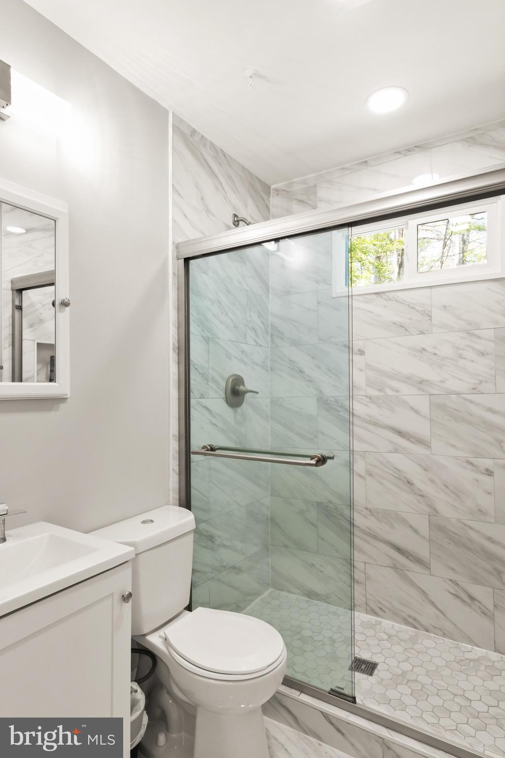 7516 Essex Avenue Springfield, VA 22150 - Photo 24 of 36 a bathroom with a shower a toilet and a sink