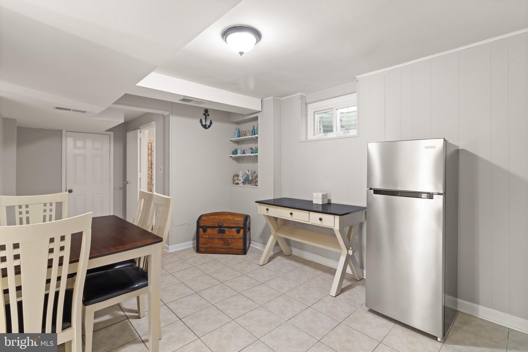 7516 Essex Avenue Springfield, VA 22150 - Photo 6 of 36 a kitchen with stainless steel appliances granite countertop a refrigerator a stove a sink dishwasher and a dining table with wooden cabinet