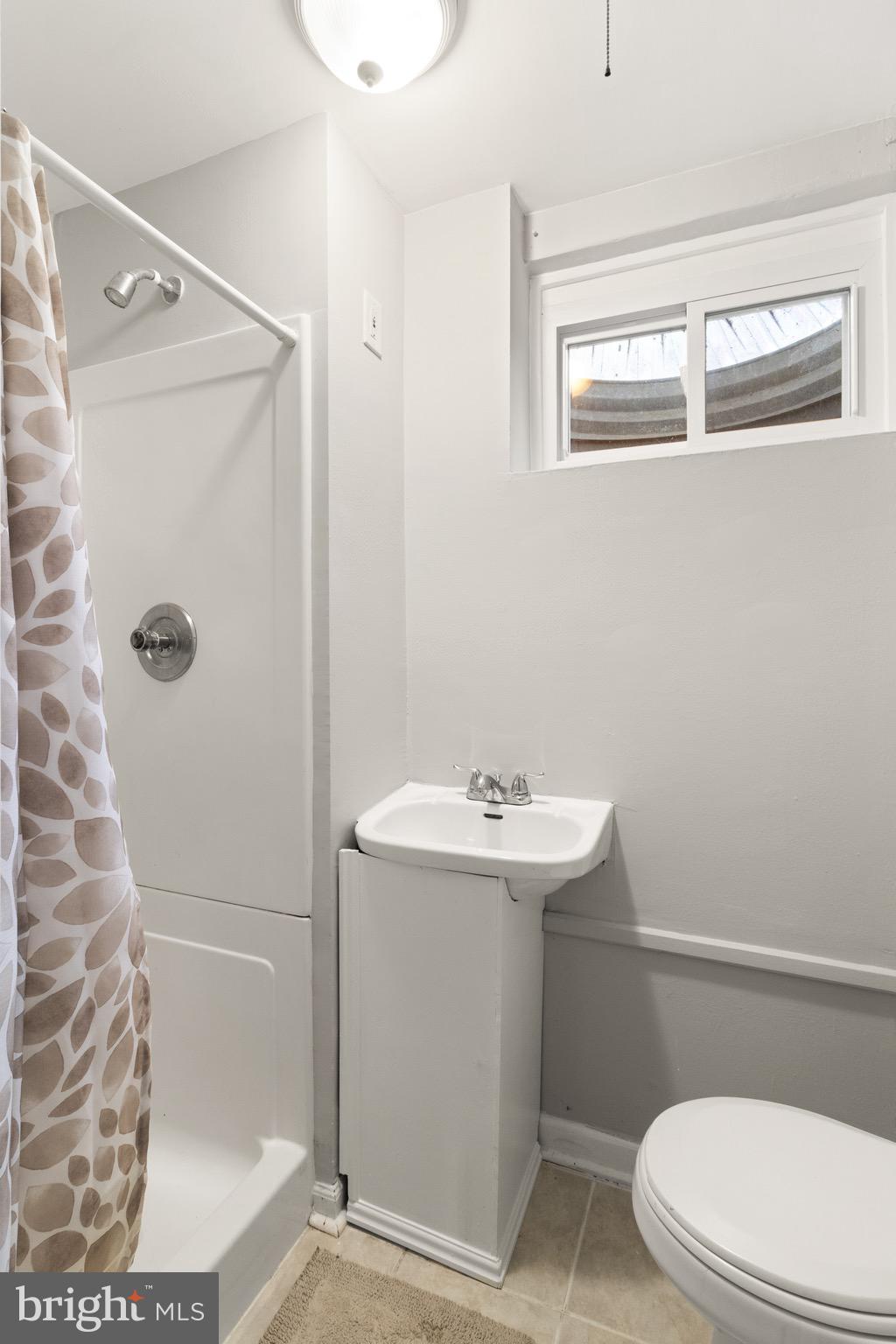 7516 Essex Avenue Springfield, VA 22150 - Photo 9 of 36 a bathroom with a sink a toilet and shower