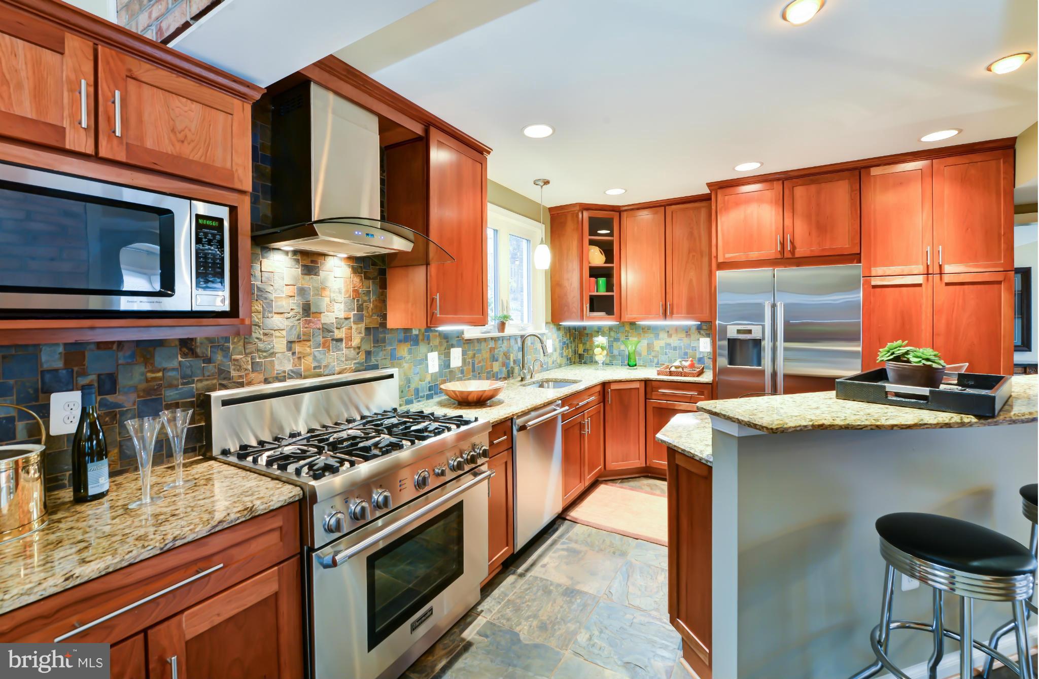 7303 Fort Hunt Road Alexandria, VA 22307 - Photo 2 of 30 a kitchen with stainless steel appliances granite countertop a stove a sink and a microwave