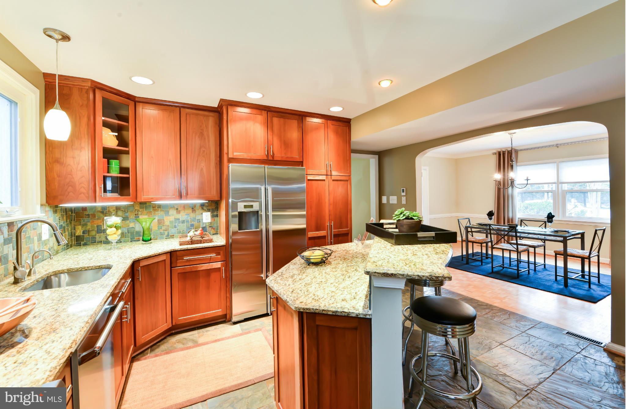 7303 Fort Hunt Road Alexandria, VA 22307 - Photo 11 of 30 a large kitchen with kitchen island a large counter top space and stainless steel appliances