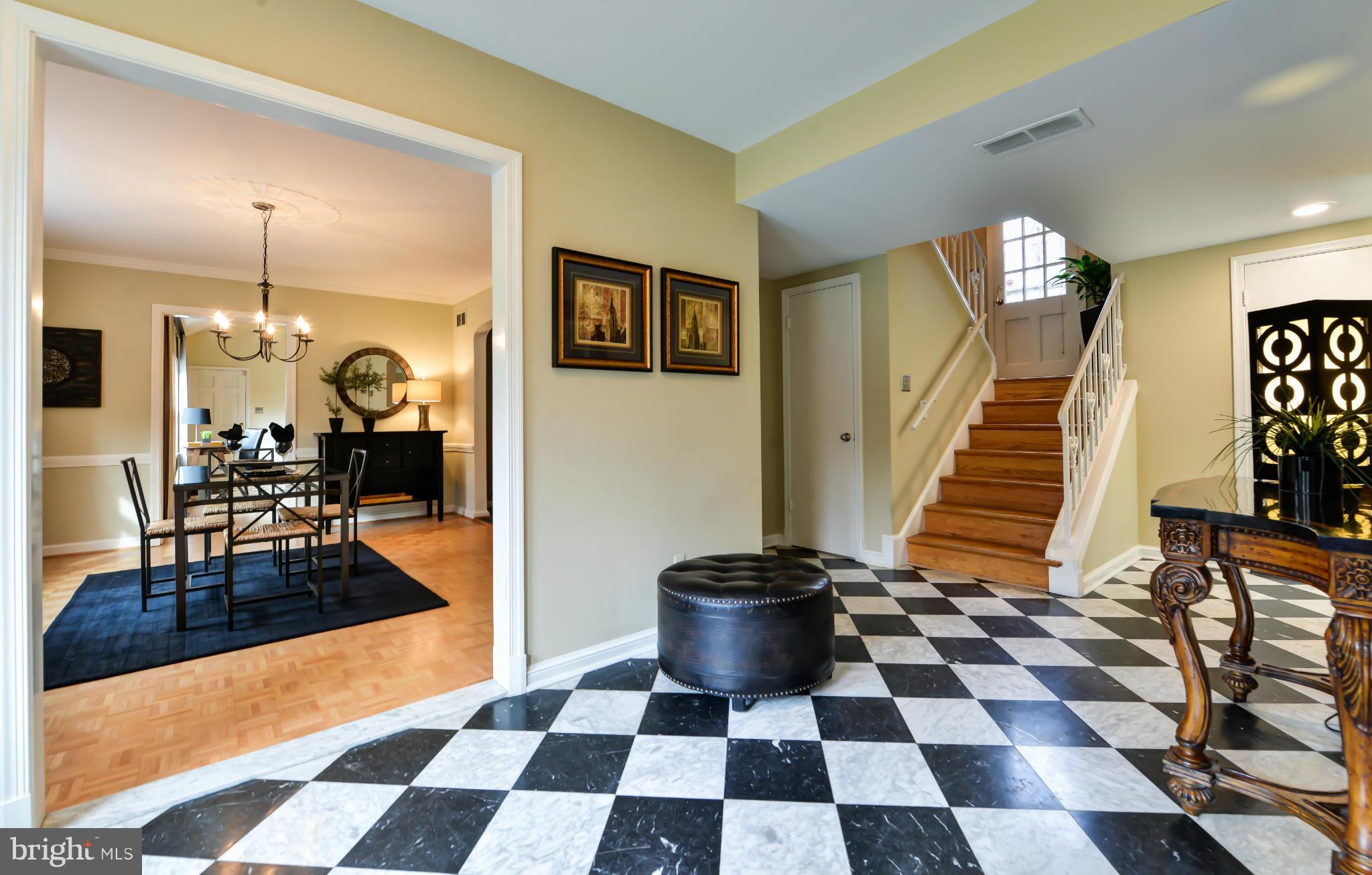 7303 Fort Hunt Road Alexandria, VA 22307 - Photo 13 of 30 a living room with a black white checkered floor with couches chair and a coffee table