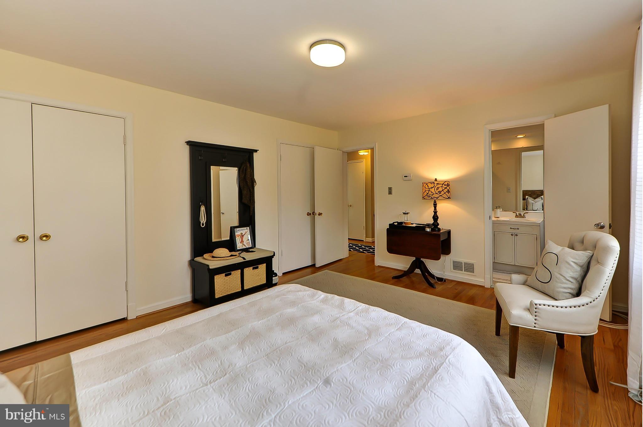 7303 Fort Hunt Road Alexandria, VA 22307 - Photo 20 of 30 a bedroom with a bed and a chandelier