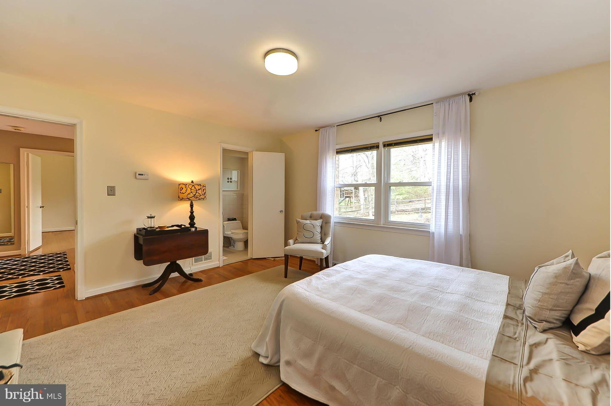 7303 Fort Hunt Road Alexandria, VA 22307 - Photo 21 of 30 a bedroom with a bed and wooden floor