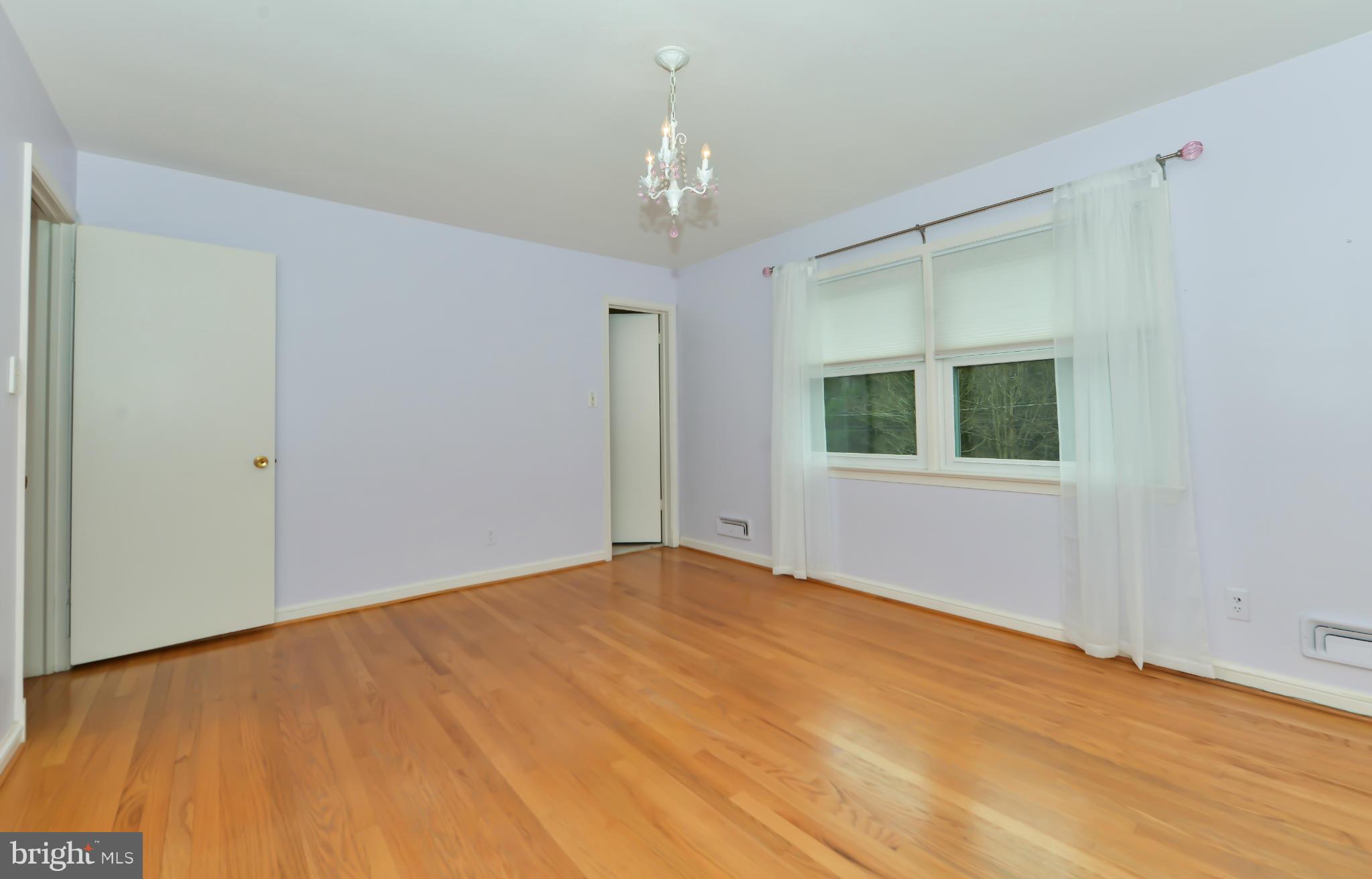 7303 Fort Hunt Road Alexandria, VA 22307 - Photo 24 of 30 a view of an empty room with window and chandelier fan