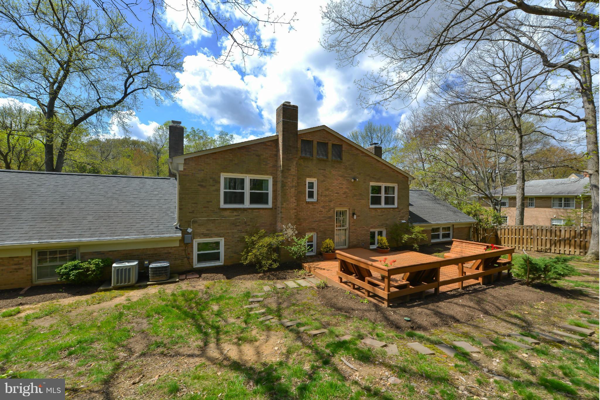 7303 Fort Hunt Road Alexandria, VA 22307 - Photo 30 of 30 a backyard of a house with barbeque oven and outdoor seating