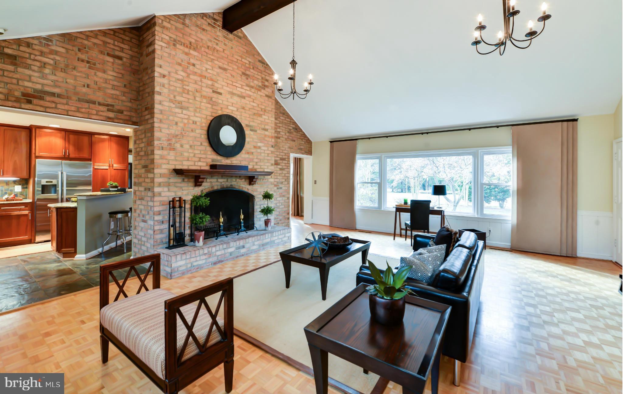7303 Fort Hunt Road Alexandria, VA 22307 - Photo 5 of 30 a living room with furniture a fireplace and a floor to ceiling window