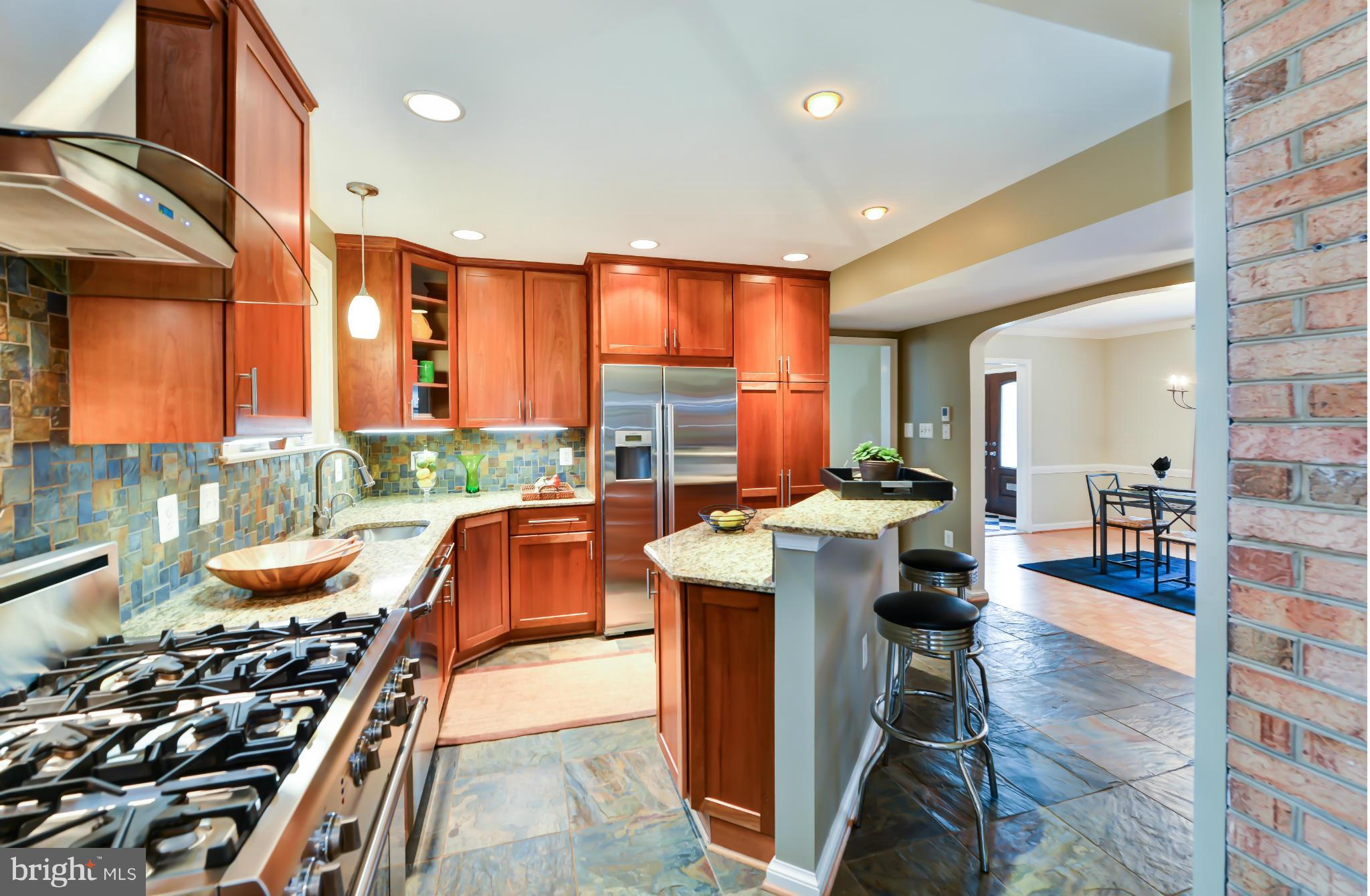 7303 Fort Hunt Road Alexandria, VA 22307 - Photo 9 of 30 a kitchen with stainless steel appliances granite countertop a stove a sink and a refrigerator