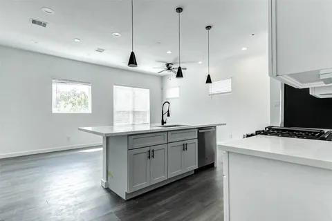 a kitchen with a sink a window and stainless steel appliances