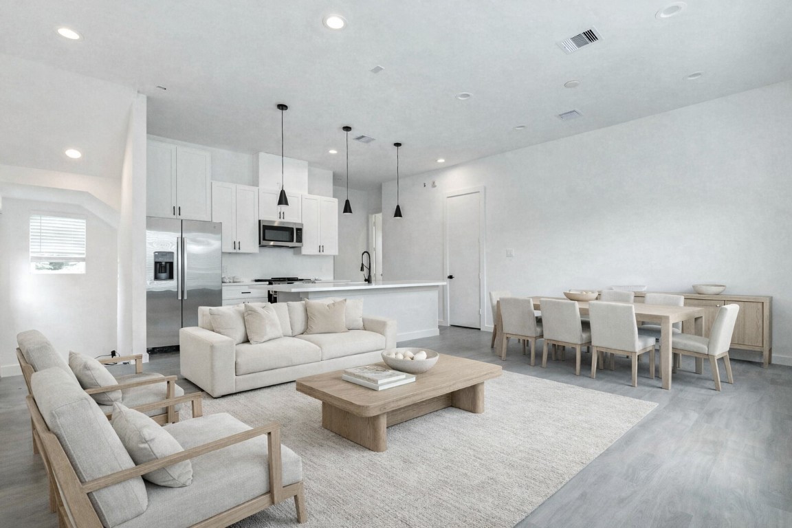 6015 Beall Street Houston, TX 77091 - Photo 2 of 26 a living room with furniture white walls and kitchen view