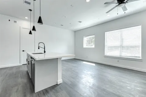 a view of a kitchen with a sink hardwood floor and a window