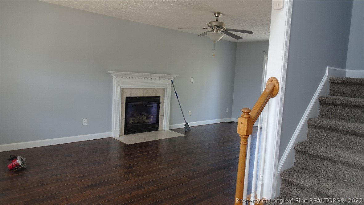265 Hillandale Road Spring Lake, NC 28390 - Photo 8 of 28 a view of a livingroom with wooden floor and a ceiling fan