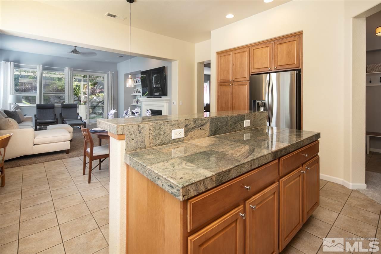 3545 Rock Ridge Court Reno, NV 89512 - Photo 10 of 33 a kitchen with stainless steel appliances granite countertop a sink and a refrigerator