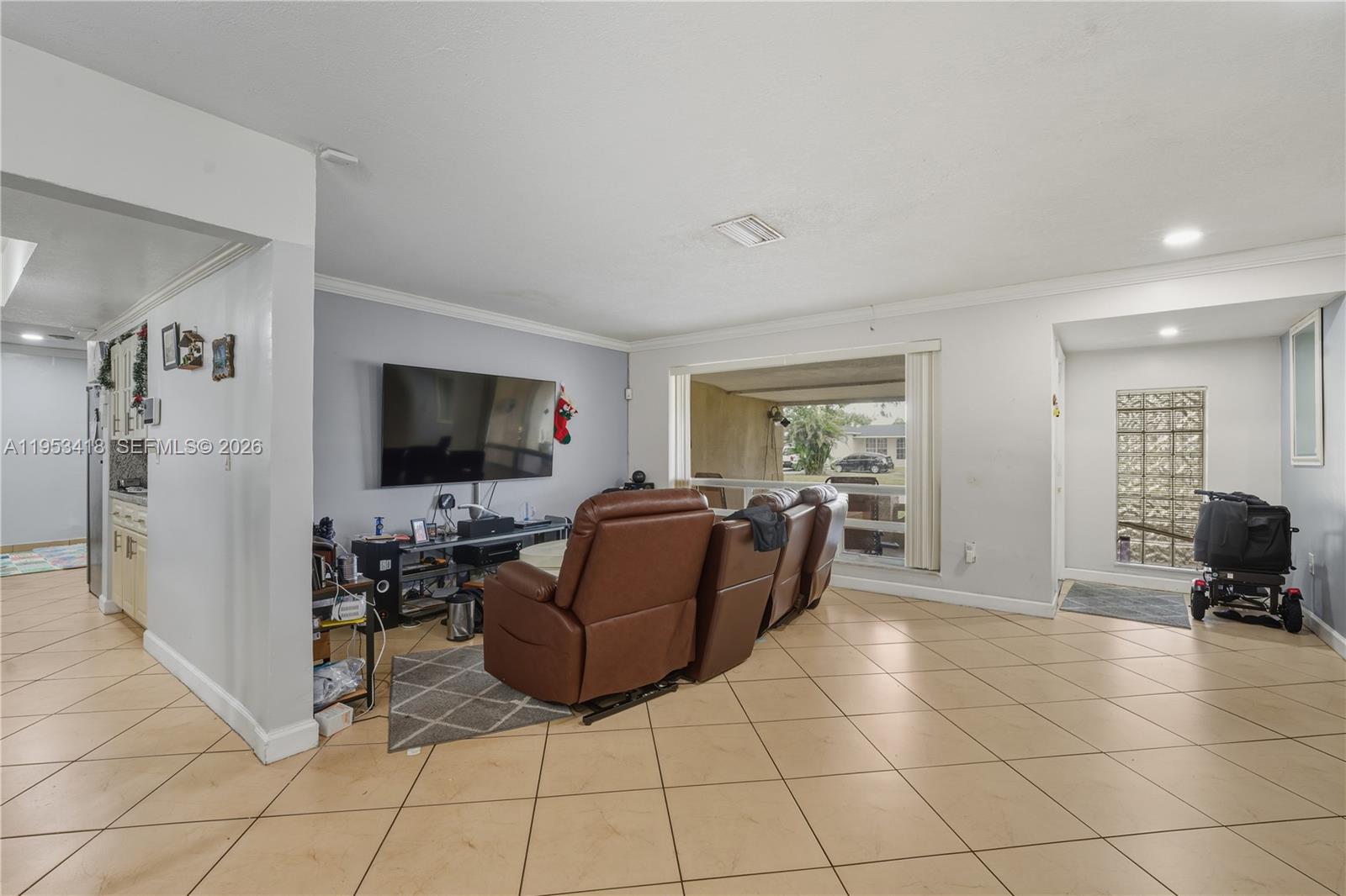 7630 Embassy Boulevard Miramar, FL 33023 - Photo 12 of 17 a living room with furniture and a flat screen tv