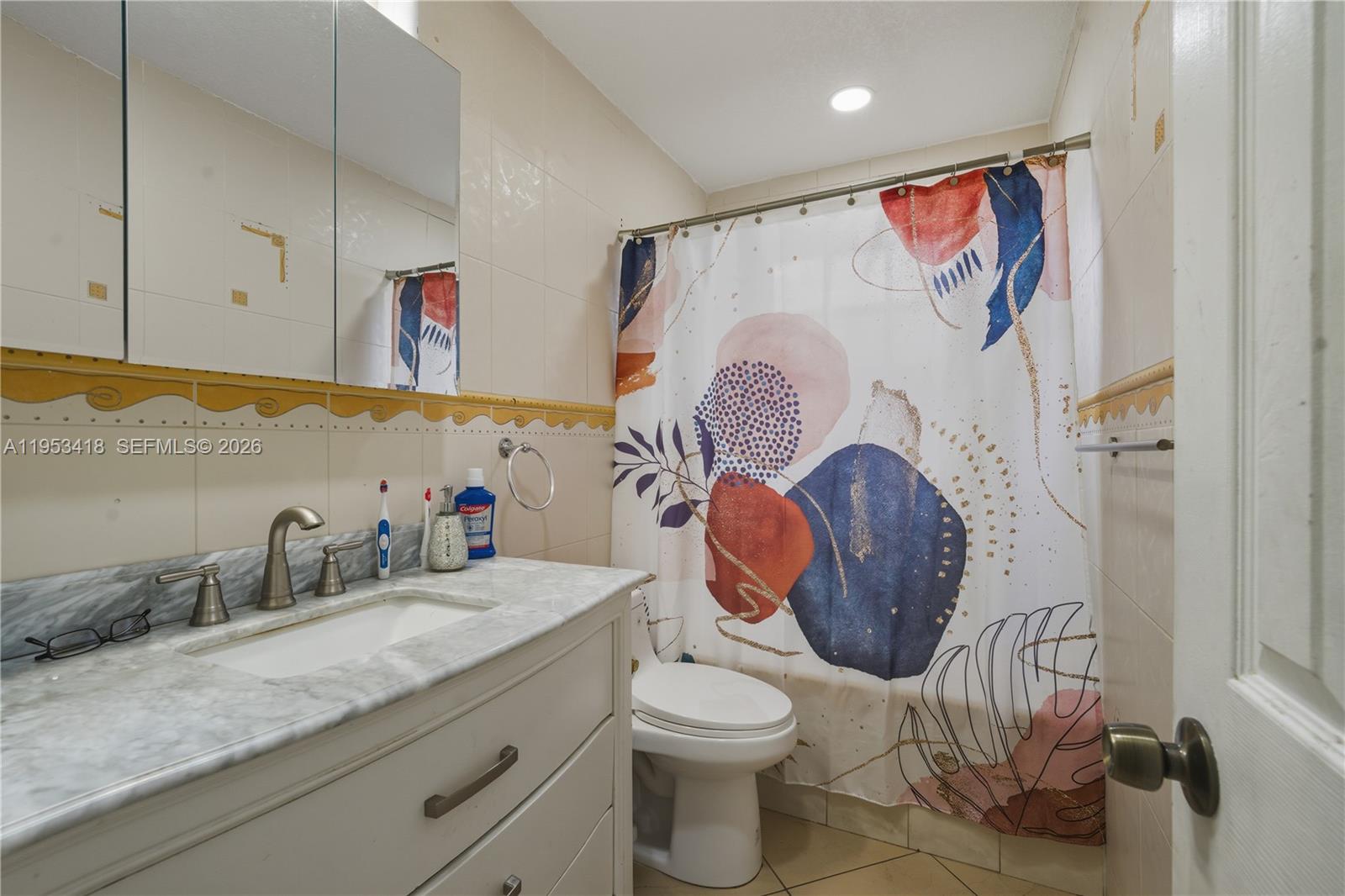 7630 Embassy Boulevard Miramar, FL 33023 - Photo 17 of 17 a bathroom with a toilet sink and mirror