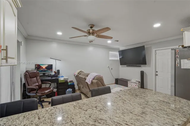 a bedroom with furniture and a flat screen tv