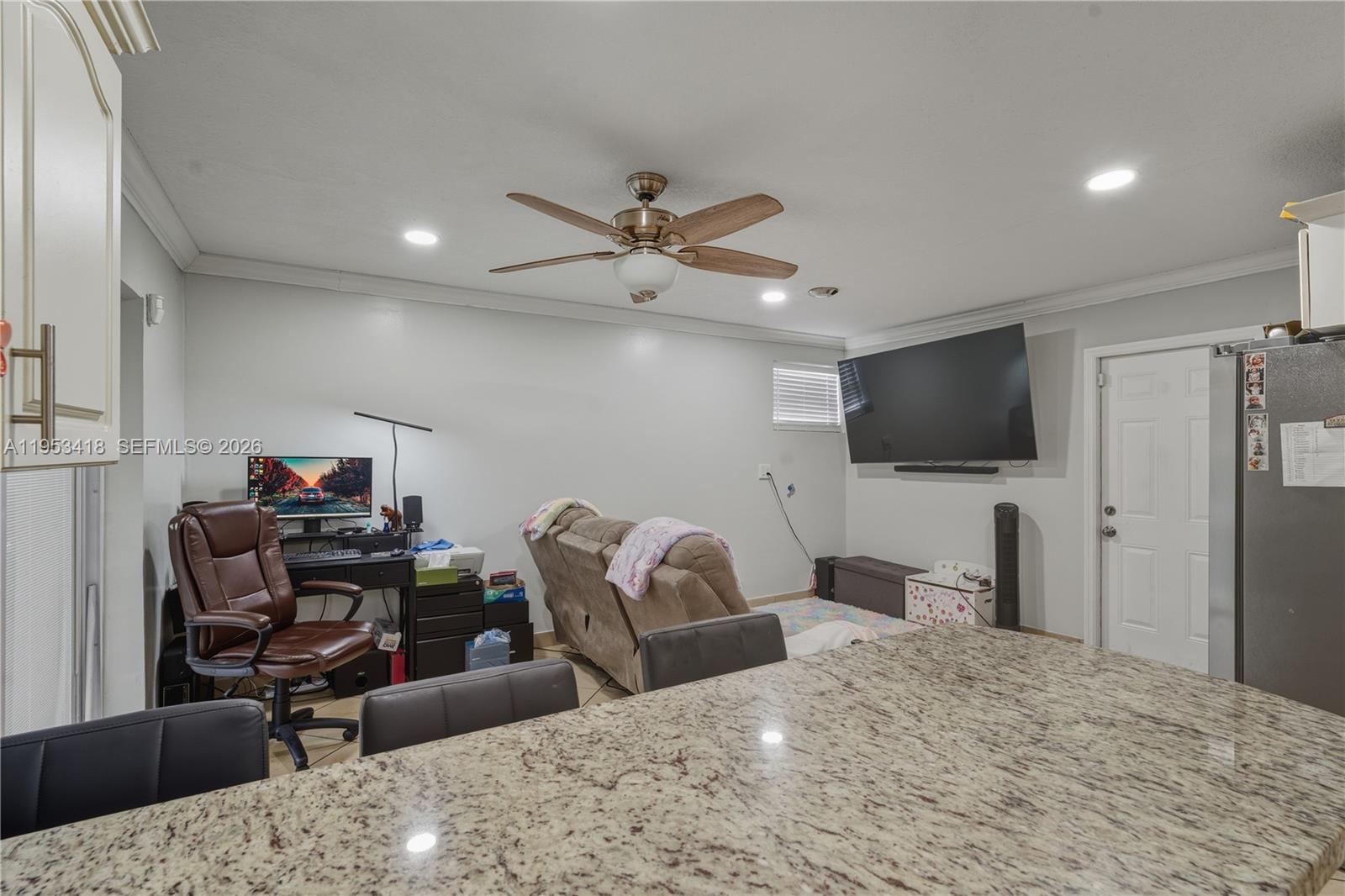 7630 Embassy Boulevard Miramar, FL 33023 - Photo 8 of 17 a bedroom with furniture and a flat screen tv