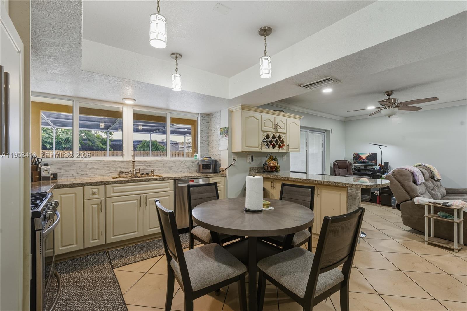 7630 Embassy Boulevard Miramar, FL 33023 - Photo 9 of 17 a kitchen with a dining table cabinets and chairs