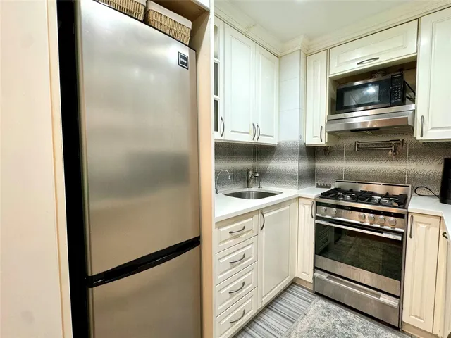 a kitchen with a stove microwave and refrigerator
