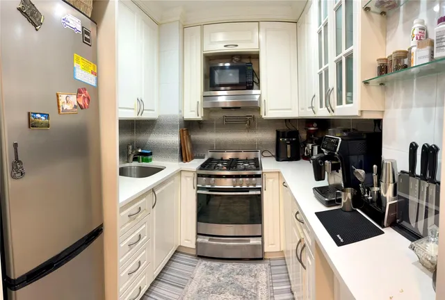 a kitchen with granite countertop a stove and a refrigerator