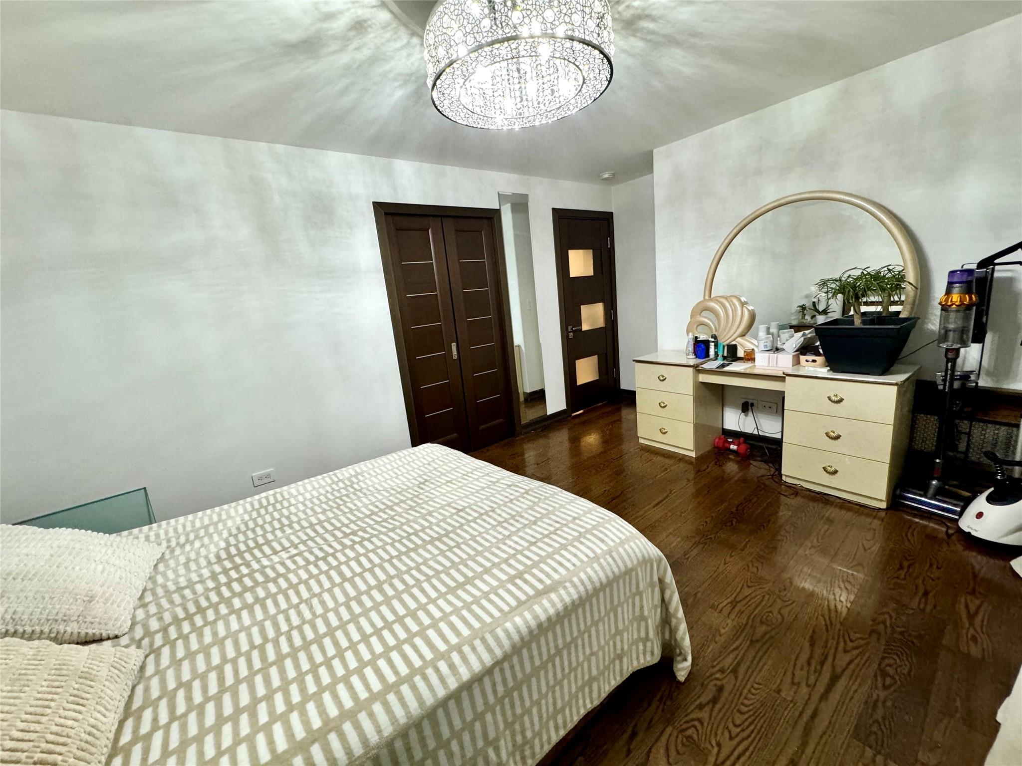 2121 Shore Parkway, Unit 4P Brooklyn, NY 11214 - Photo 5 of 20 a bedroom with a bed and a chandelier