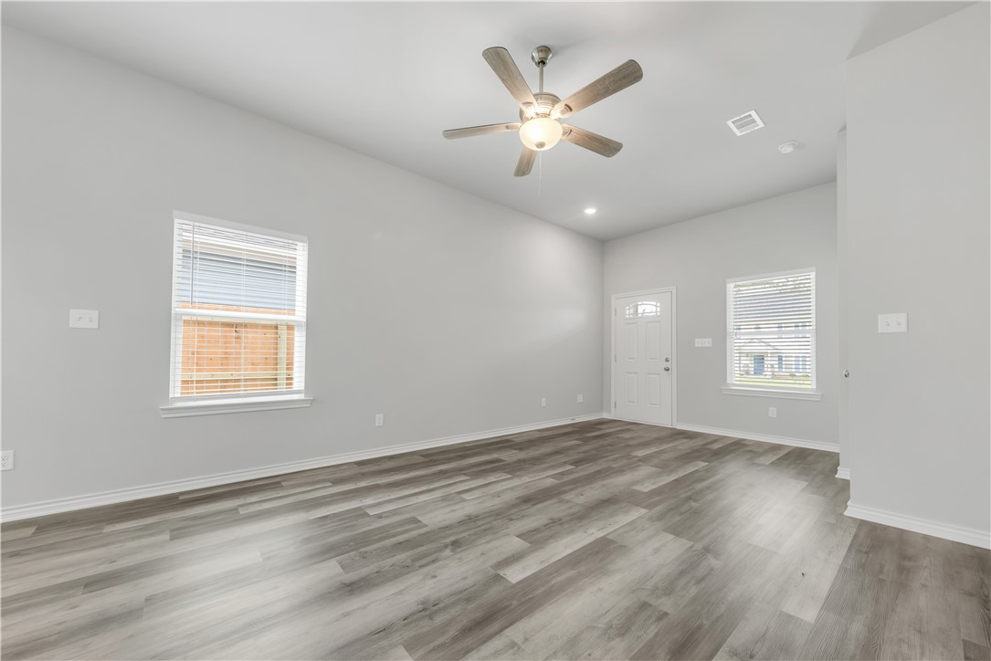 1805 Pin Oak Street Bryan, TX 77803 - Photo 8 of 20 Empty room featuring ceiling fan, wood finished floors, and recessed lighting