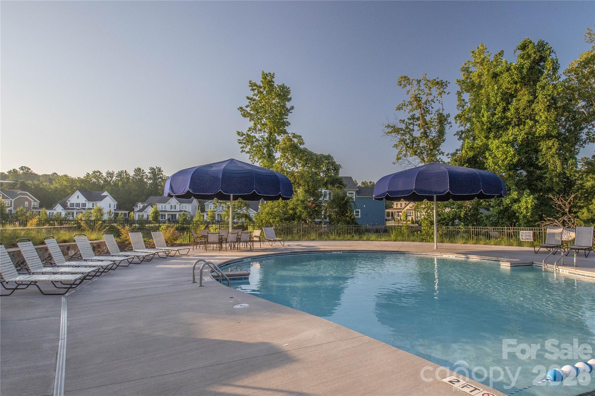 1633 Half Pint Loop Fort Mill, SC 29708 - Photo 39 of 48 a view of a swimming pool with a table and chairs under an umbrella