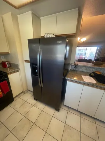a kitchen with a refrigerator and washing machine