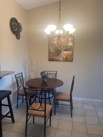 a view of a dining room with furniture and chandelier